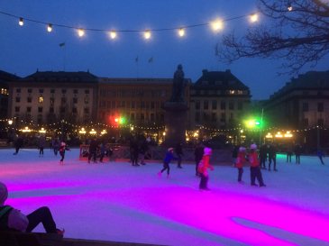 Children skating in the town centre during early evening hours.